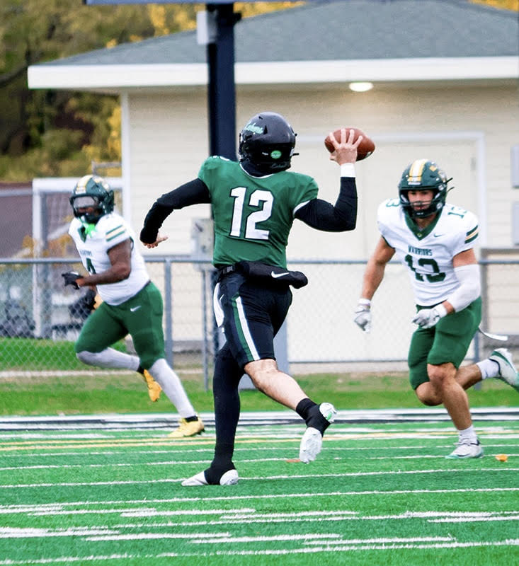 Tony Chahino in football uniform preparing to throw during game action